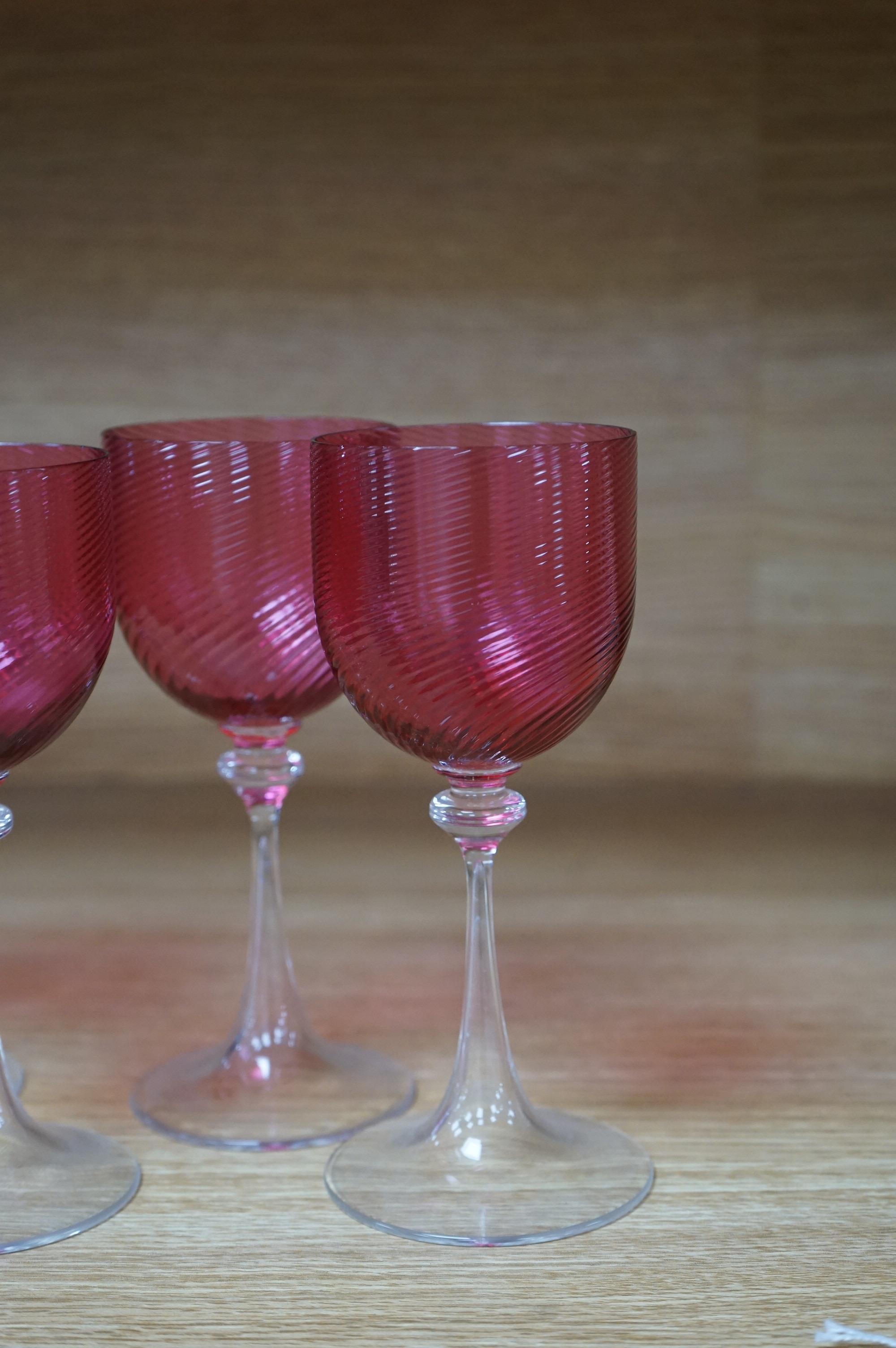 A set of eight cranberry bowl, flute stemmed wine glasses, 16.5cm high